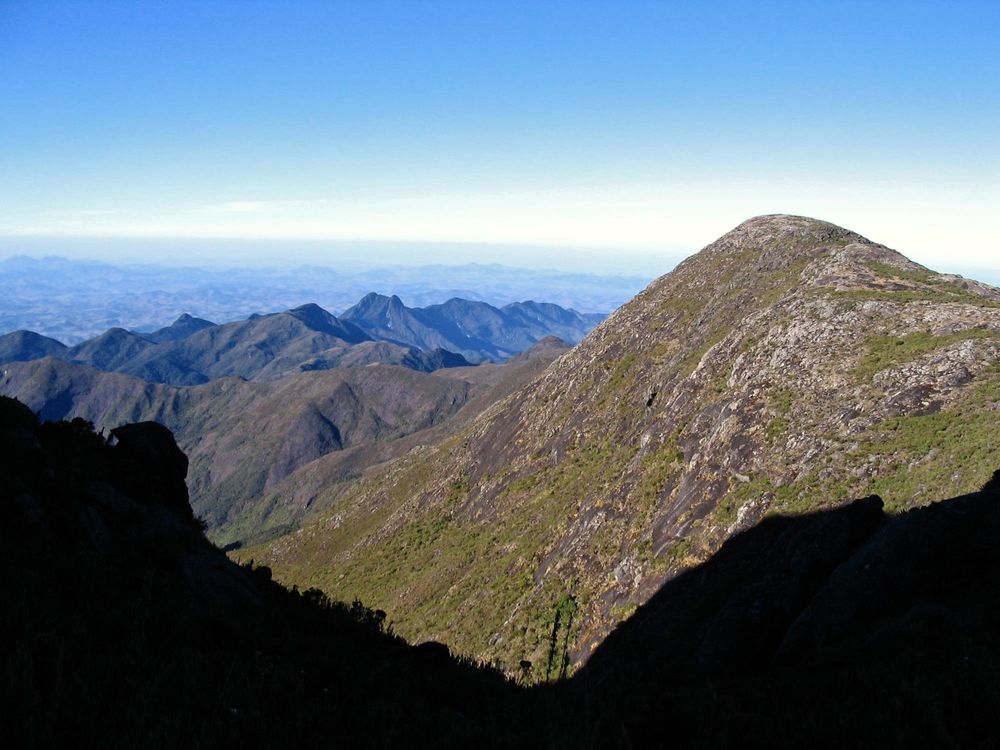 Encosta de campo de altitude pelo lado capixaba, com o vale e as cristas ao fundo